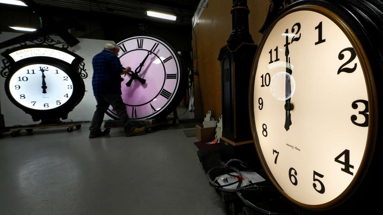 Clockmaker Scott Gow adjusts the hands of a clock at the Electric Time Company, Oct. 30, 2024, in Medfield, Mass. The Senate is unlikely to act on a House-passed bill to make daylight saving time permanent.