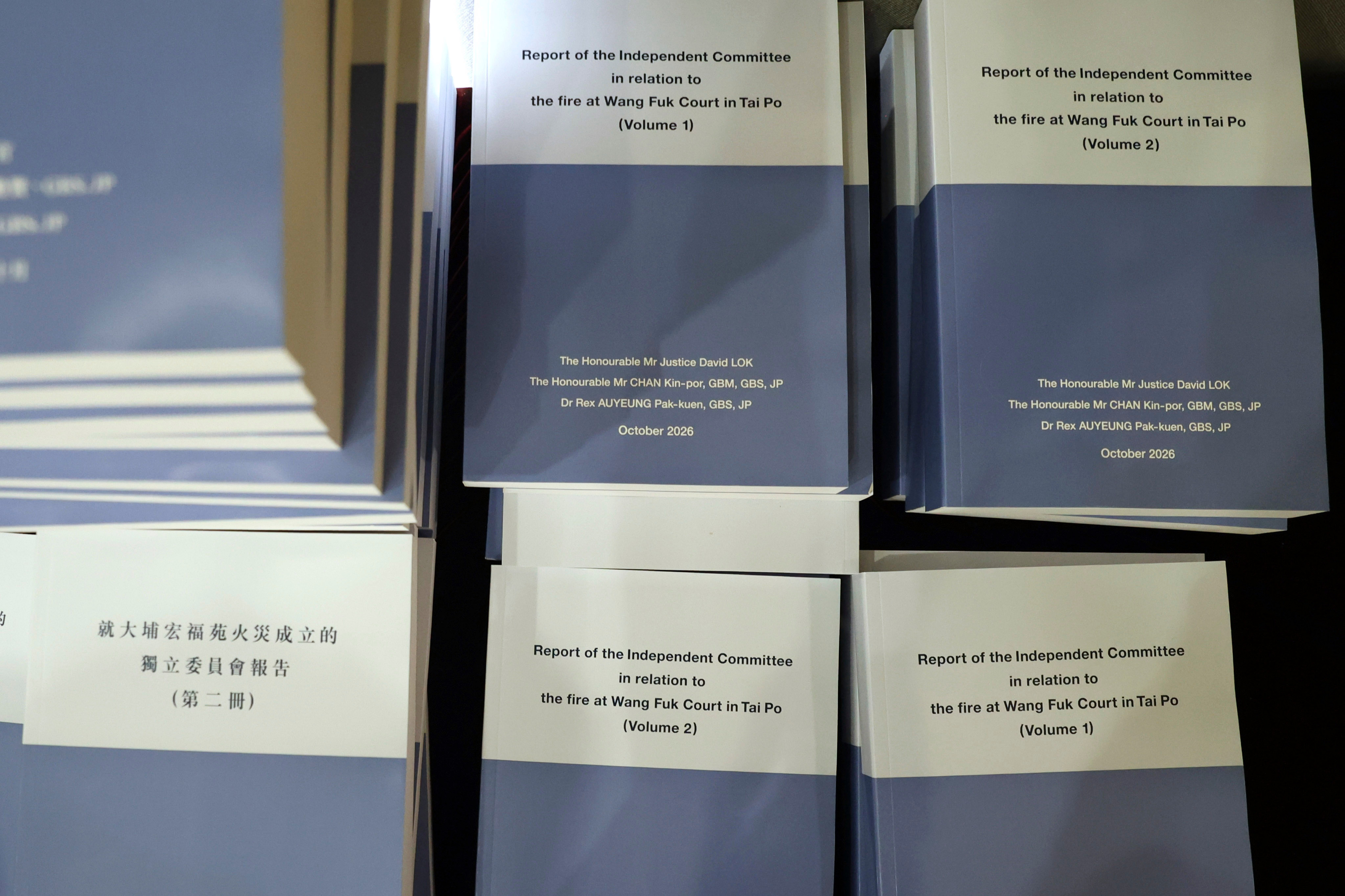 Copies of the Wang Fuk Court fire inquiry report are seen before a press conference in Hong Kong, Thursday. At least 168 were killed and thousands more were displaced in November's fire.