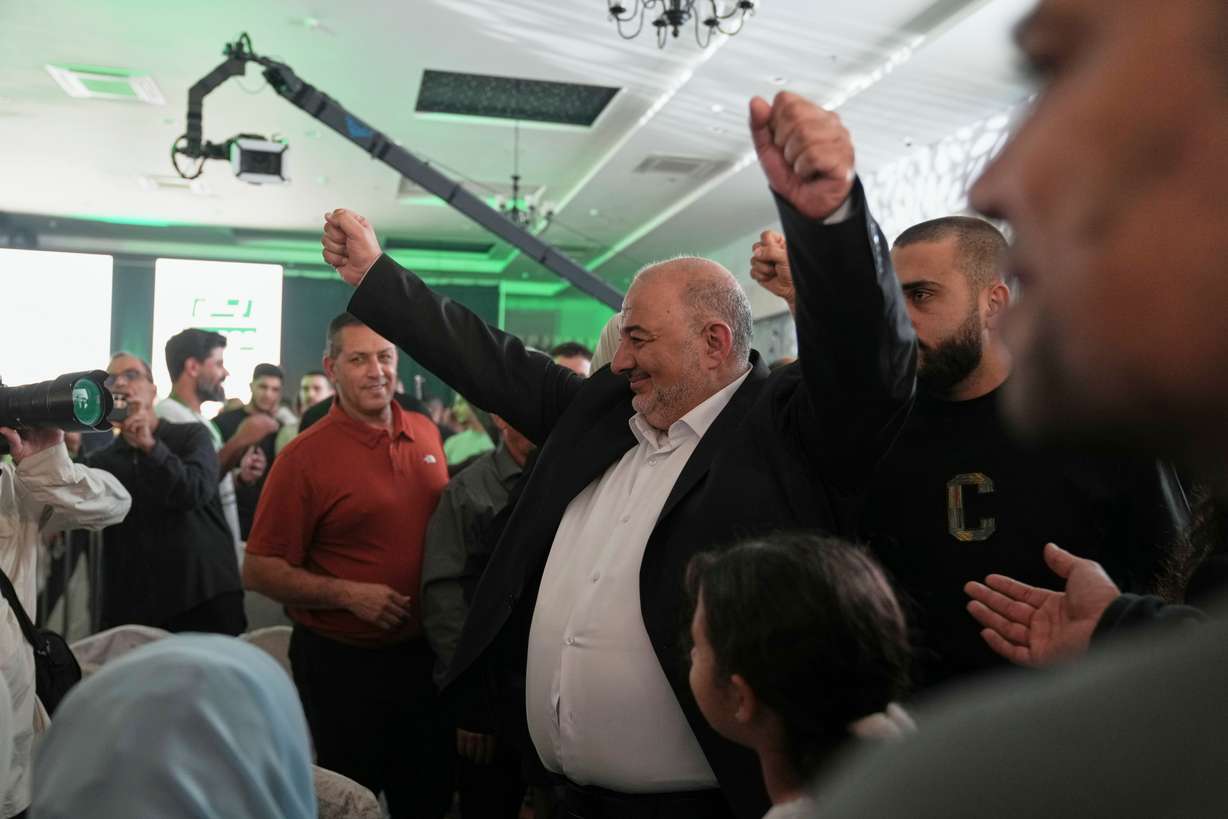 Israeli lawmaker Mansour Abbas, leader of the Ra'am party, raises his fists as he greets supporters after the release of the first exit poll results in Israel's general election in Sakhnin, Israel, Tuesday. Abbas on Thursday welcomed an investigation into foreign interference into Israeli elections.