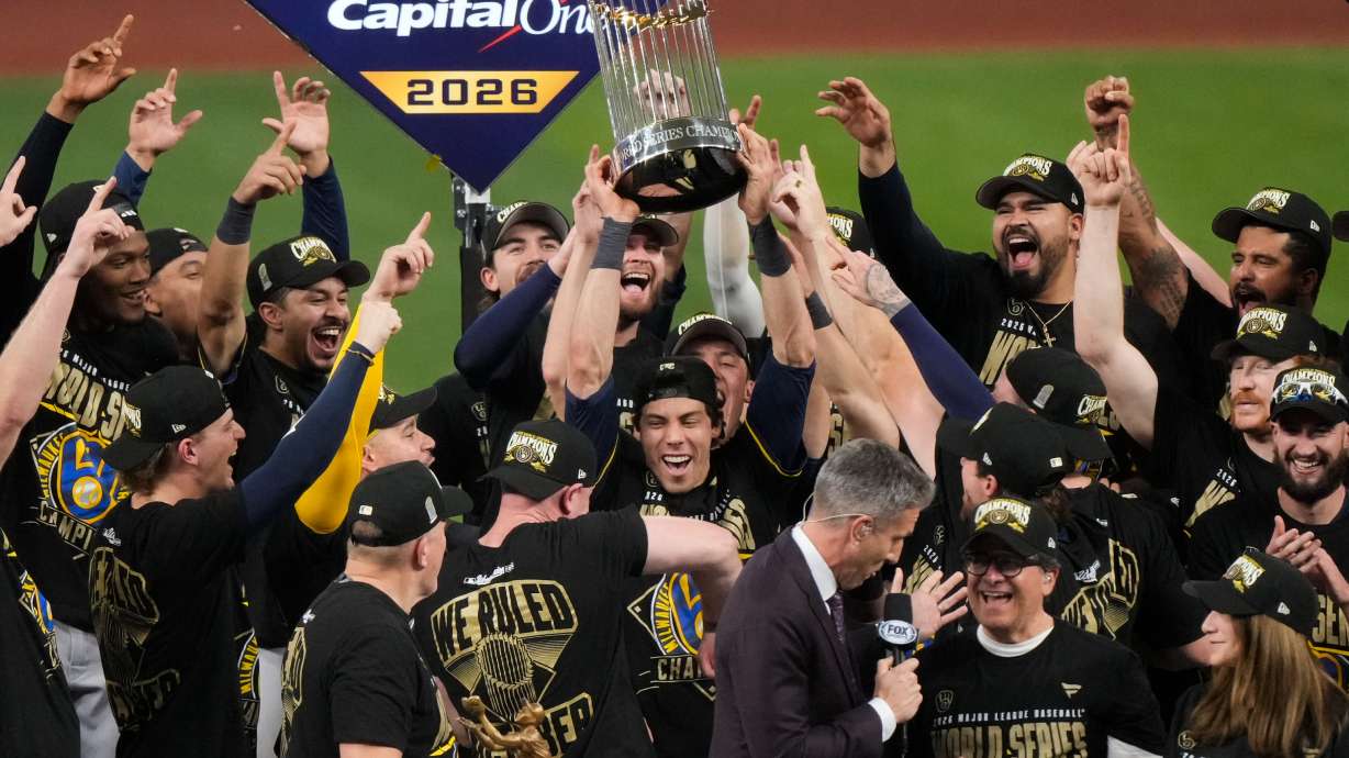 Milwaukee Brewers designated hitter Christian Yelich holds the World Series trophy with teammates after winning baseball's World Series, against the Tampa Bay Rays, Wednesday, Oct. 28, 2026, in St. Petersburg, Fla.