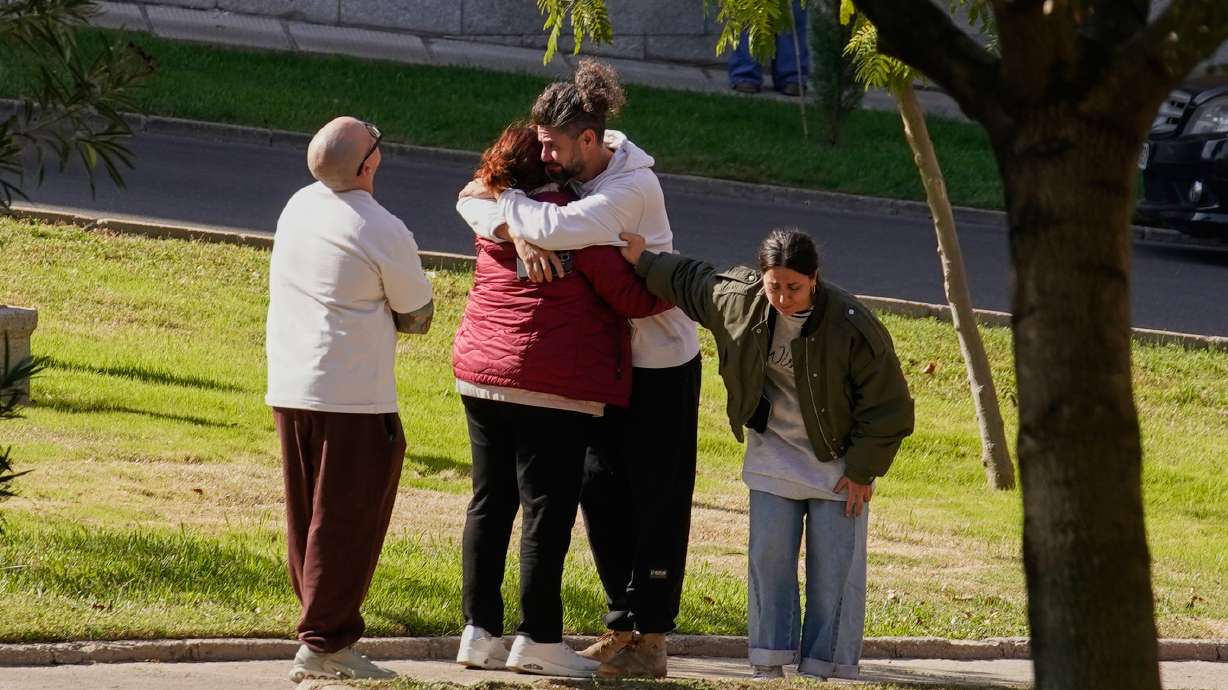 People searching for relatives who were traveling on the trains involved in a collision gather at a religious residence converted into a temporary medical facility in Toledo, Spain, Thursday.