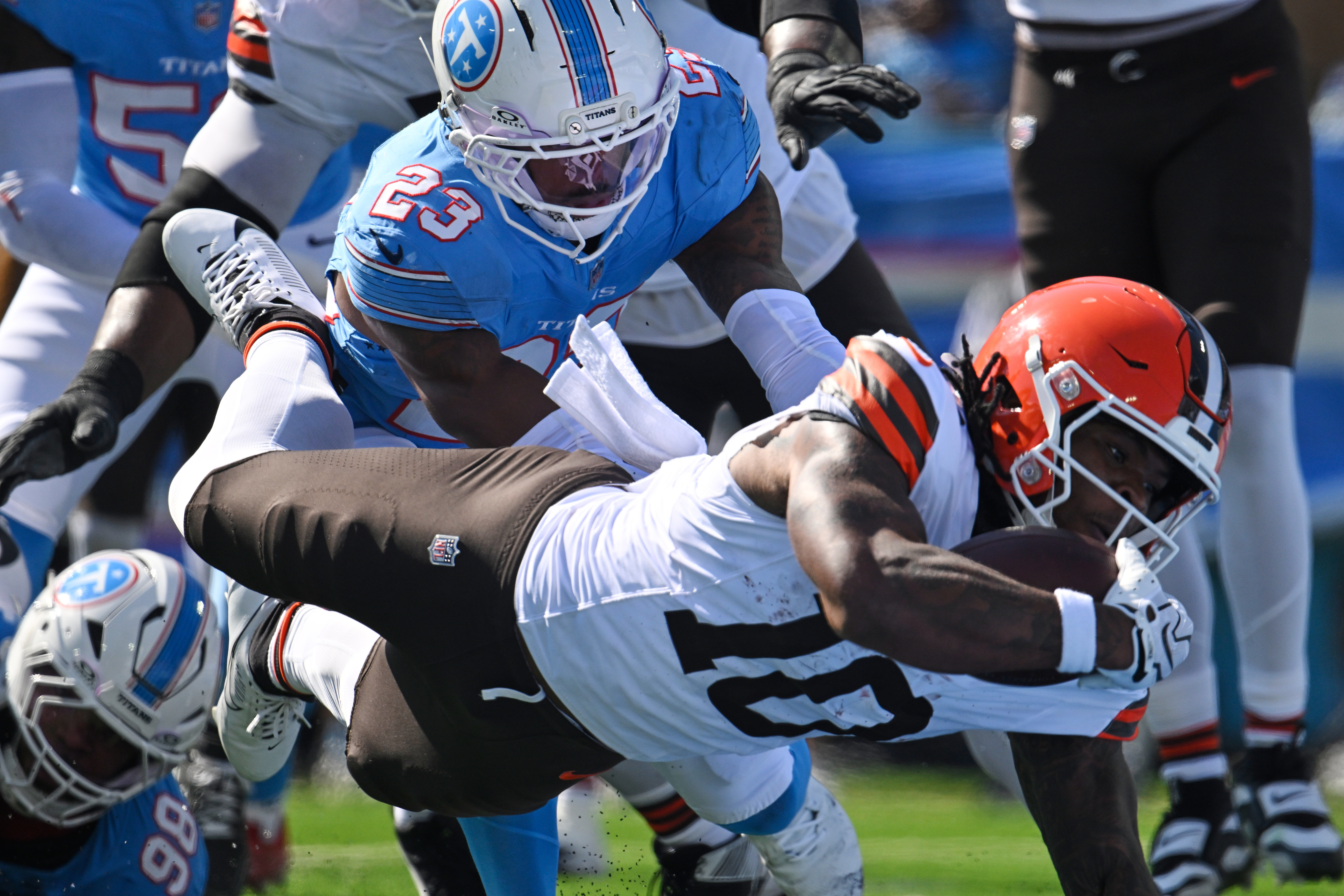 Cleveland Browns running back Quinshon Judkins (10) dives past Tennessee Titans safety Kevin Winston Jr. (23) and defensive tackle Jeffery Simmons (98) to score a touchdown during the first half of an NFL football game in Nashville, Tenn., Sunday, Oct. 25, 2026. 