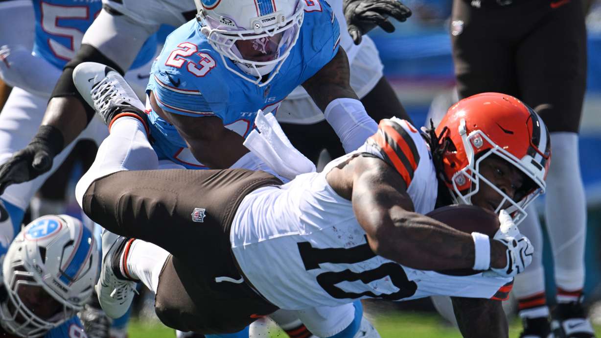 Cleveland Browns running back Quinshon Judkins (10) dives past Tennessee Titans safety Kevin Winston Jr. (23) and defensive tackle Jeffery Simmons (98) to score a touchdown during the first half of an NFL football game in Nashville, Tenn., Sunday, Oct. 25, 2026.