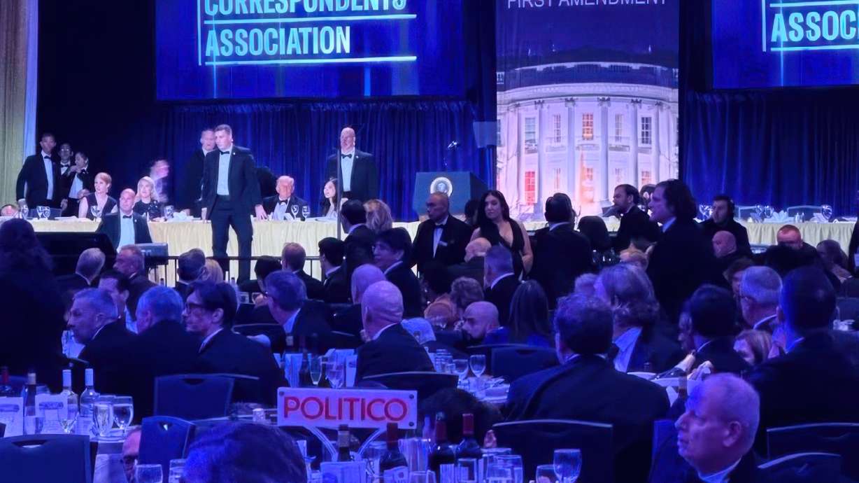 Secret Service agents respond near President Donald Trump and first lady Melania Trump during the White House Correspondents Dinner, April 25, in Washington. The man charged with attempting to kill Trump at the dinner had a trial date set for September 2027 on Thursday.