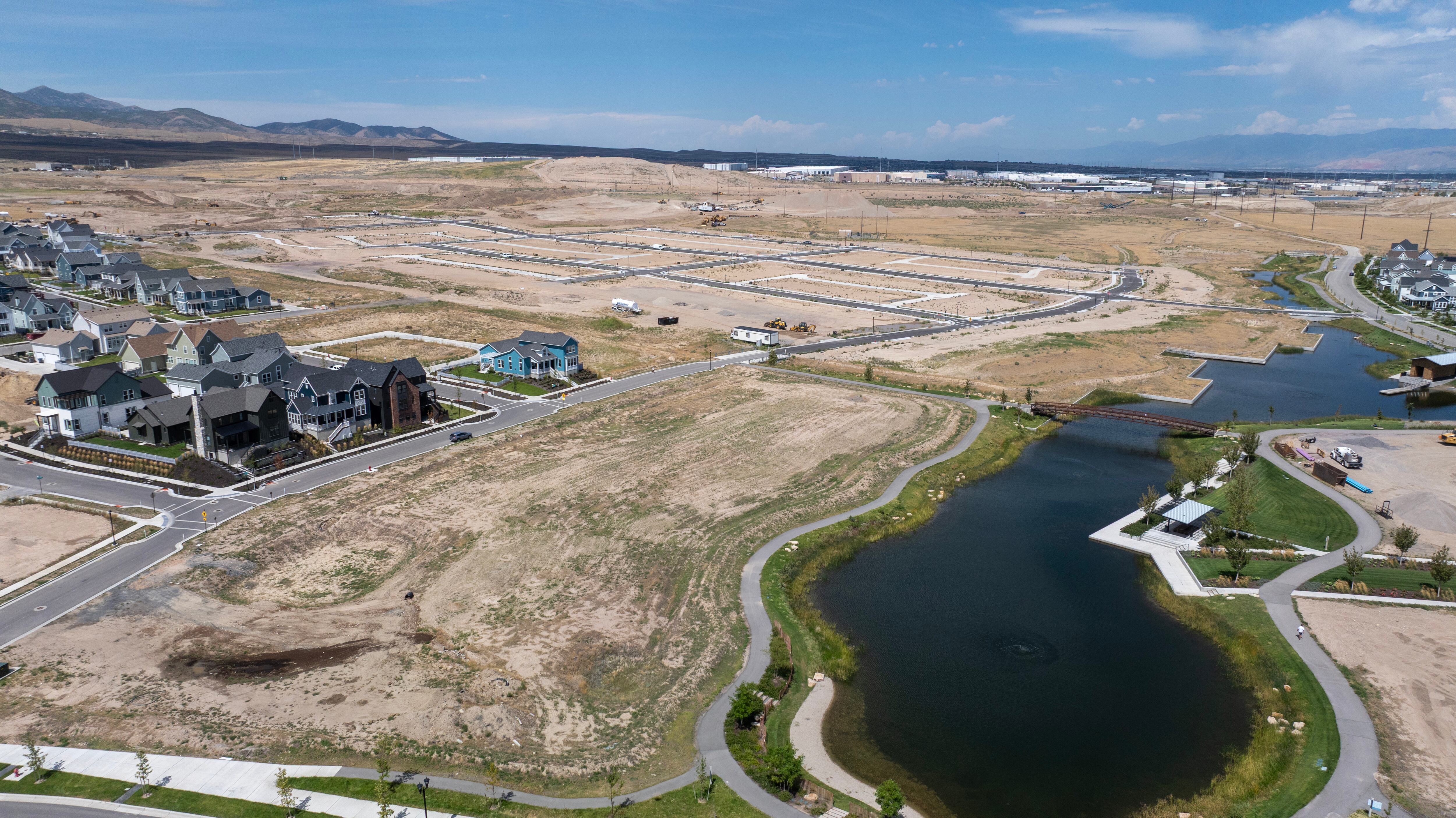 New homes and apartments sit on the edge of ground that is being prepared for development in the South Jordan area on Monday, Aug. 24, 2026.