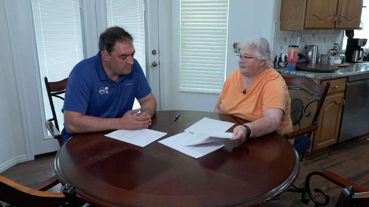 Marsha Worthen reviews paperwork with KSL’s Matt Gephardt at her West Valley City home after paying EcoView Windows and Doors a $5,492 deposit for doors that never arrived.
