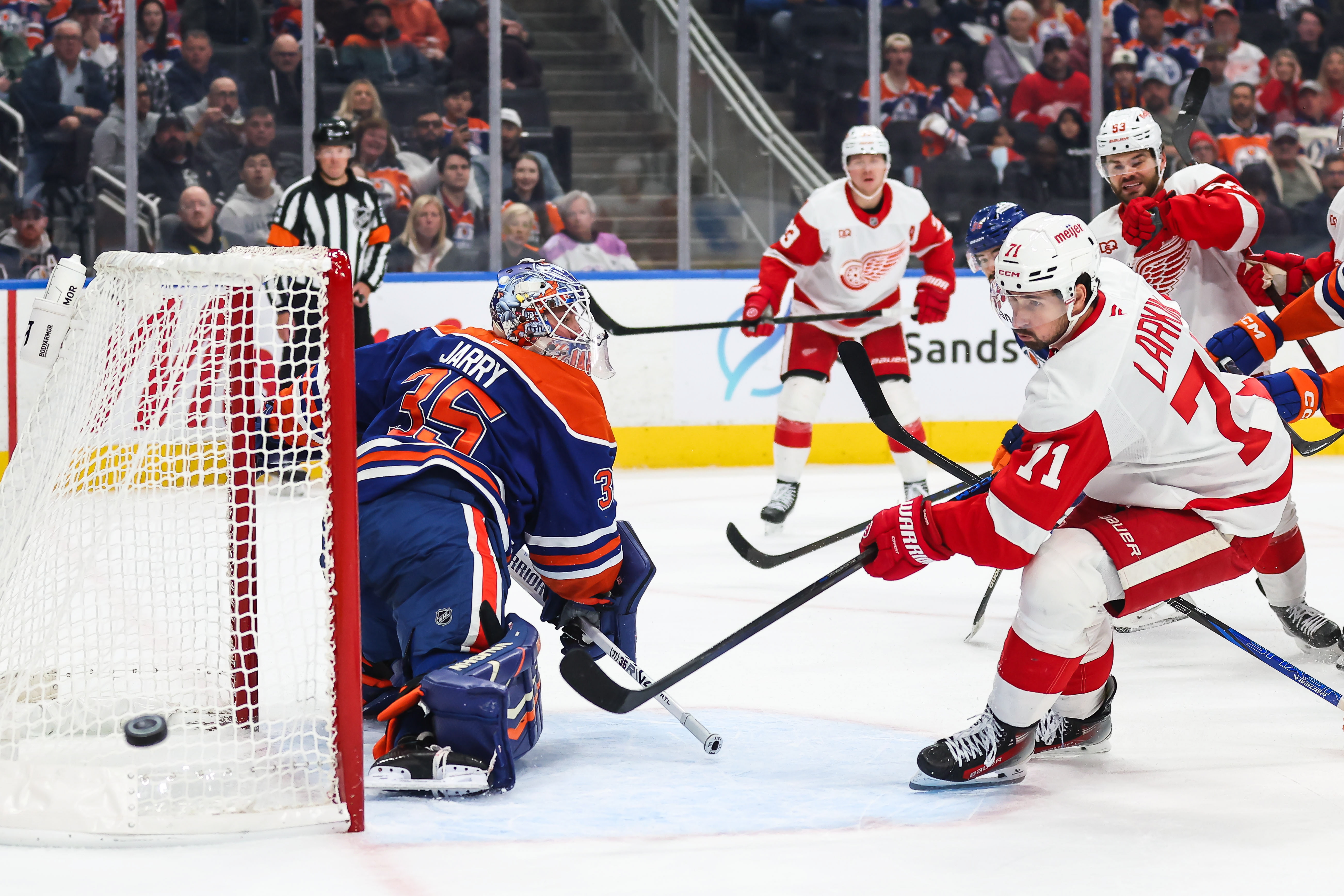 Edmonton Oilers goaltender Tristan Jarry (35) defends the net against Detroit Red Wings' Dylan Larkin (71) during the first period of an NHL hockey game in Edmonton, Alberta, Monday, Oct. 26, 2026. 