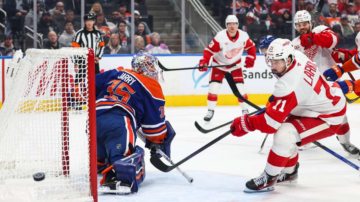 Edmonton Oilers goaltender Tristan Jarry (35) defends the net against Detroit Red Wings' Dylan Larkin (71) during the first period of an NHL hockey game in Edmonton, Alberta, Monday, Oct. 26, 2026.