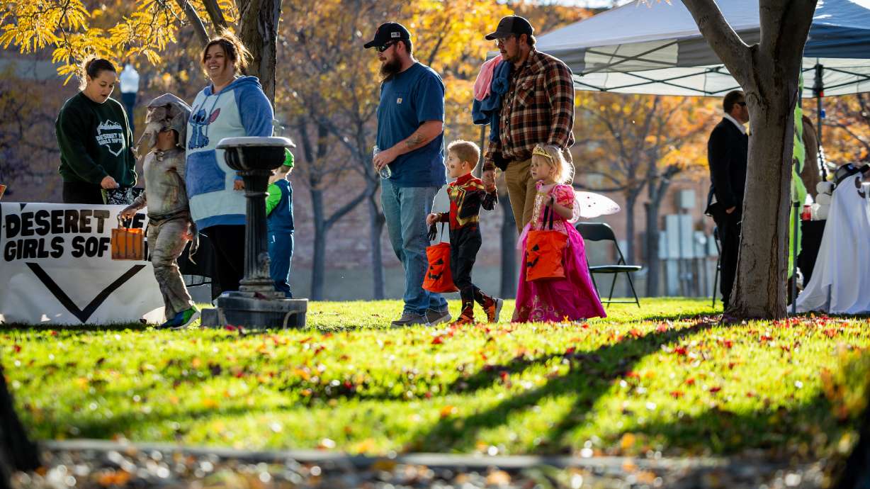 People trick-or-treat during the Tooele City Downtown Halloween Trick-or-Treat Main Street in Tooele on Oct. 31, 2025. Scattered and isolated storms before an atmospheric river are possible on Friday and Halloween Saturday before wetter weather later in the weekend.