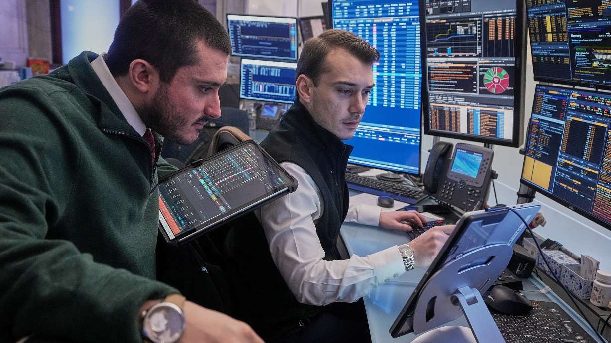 Traders Drew Cohen, left, and Dylan Halvorsan work on the floor of the New York Stock Exchange, Jan. 26. The sell-off for tech stocks on Wall Street got even worse on worries that the frenzy around AI sent prices too high.