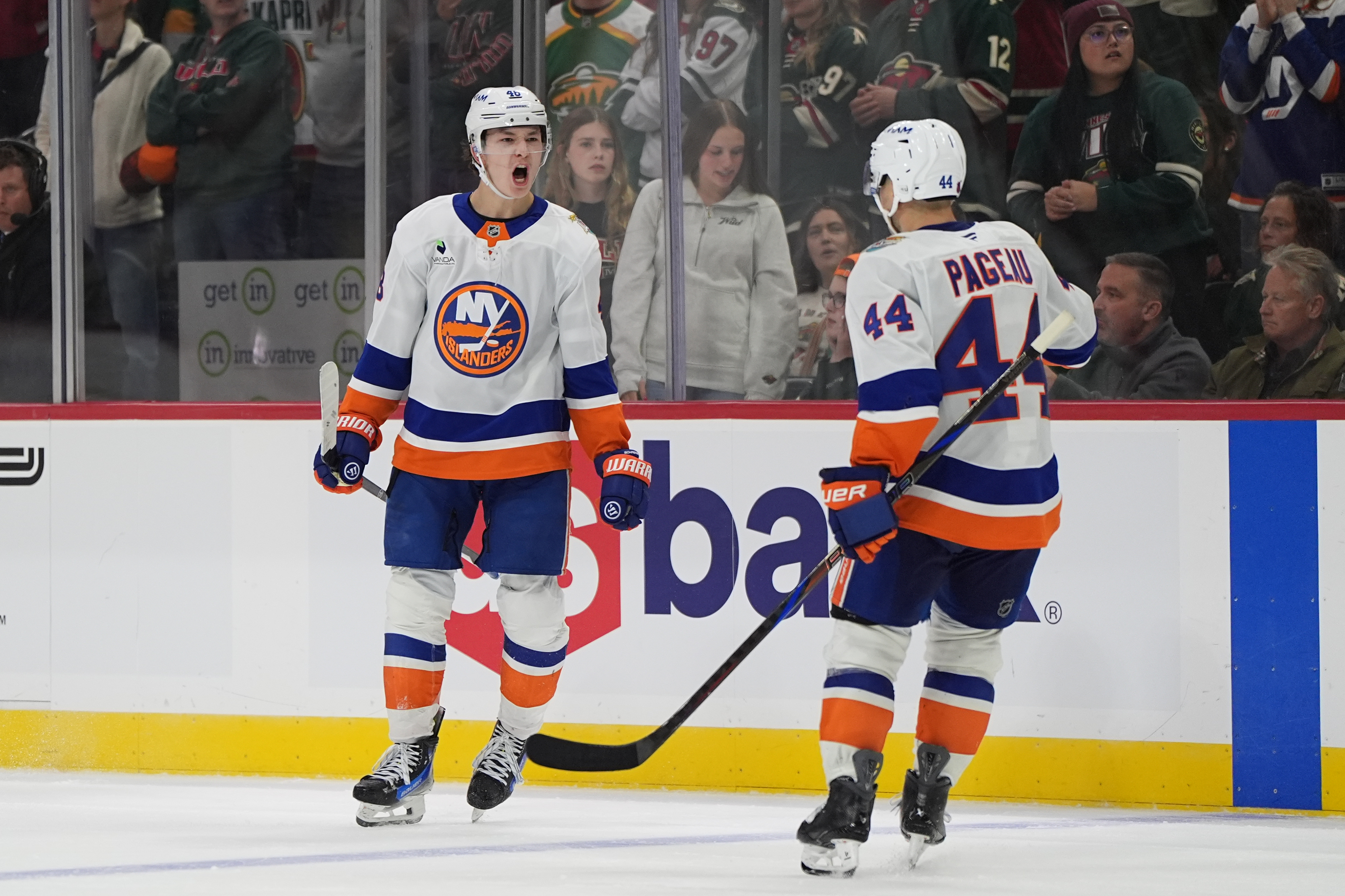 New York Islanders defenseman Matthew Schaefer, left, celebrates next to center Jean-Gabriel Pageau (44) after scoring the winning goal during overtime of an NHL hockey game against the Minnesota Wild, Thursday, Oct. 29, 2026, in St. Paul, Minn. 