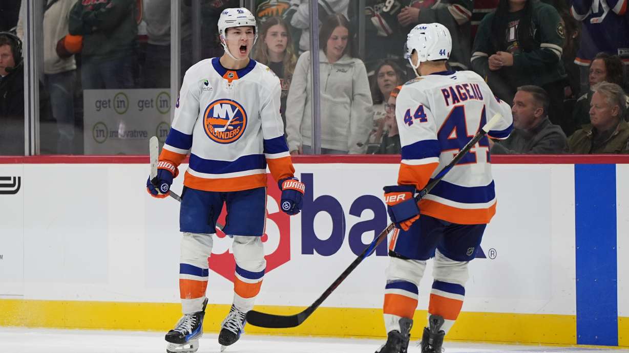 New York Islanders defenseman Matthew Schaefer, left, celebrates next to center Jean-Gabriel Pageau (44) after scoring the winning goal during overtime of an NHL hockey game against the Minnesota Wild, Thursday, Oct. 29, 2026, in St. Paul, Minn.