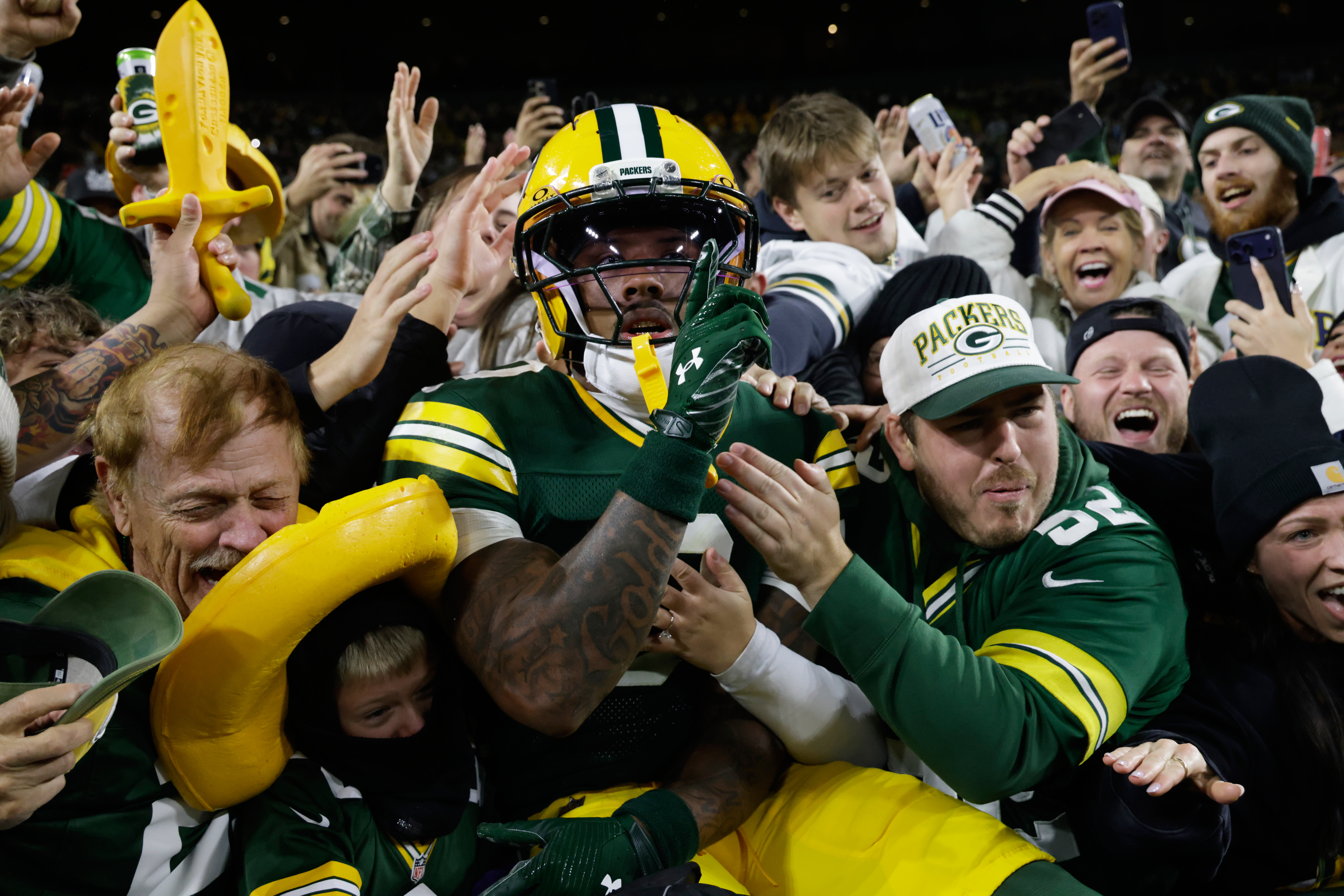 Green Bay Packers wide receiver Matthew Golden leaps into the stands as he celebrates scoring a touchdown during the first half of an NFL football game against the Carolina Panthersin Green Bay, Wis., Thursday, Oct. 29, 2026. 