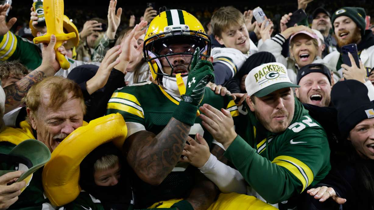 Green Bay Packers wide receiver Matthew Golden leaps into the stands as he celebrates scoring a touchdown during the first half of an NFL football game against the Carolina Panthersin Green Bay, Wis., Thursday, Oct. 29, 2026.