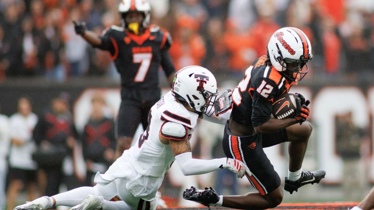 Oregon State wide receiver Jesse Legree (12) attempts to evade a tackle from Texas Tech defensive back Peyton Morgan (3) during the first half of an NCAA college football game, Saturday, Sept. 12, 2026, in Corvallis, Ore.