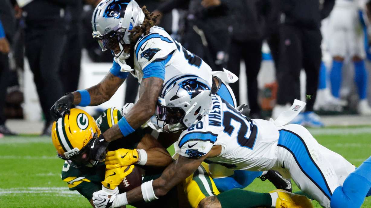 Green Bay Packers wide receiver Christian Watson, left, is tackled by Carolina Panthers cornerback Will Lee III, top, and Zakee Wheatley, Lee and Watson were injured on the play, during the first half of an NFL football game in Green Bay, Wis., Thursday, Oct. 29, 2026.
