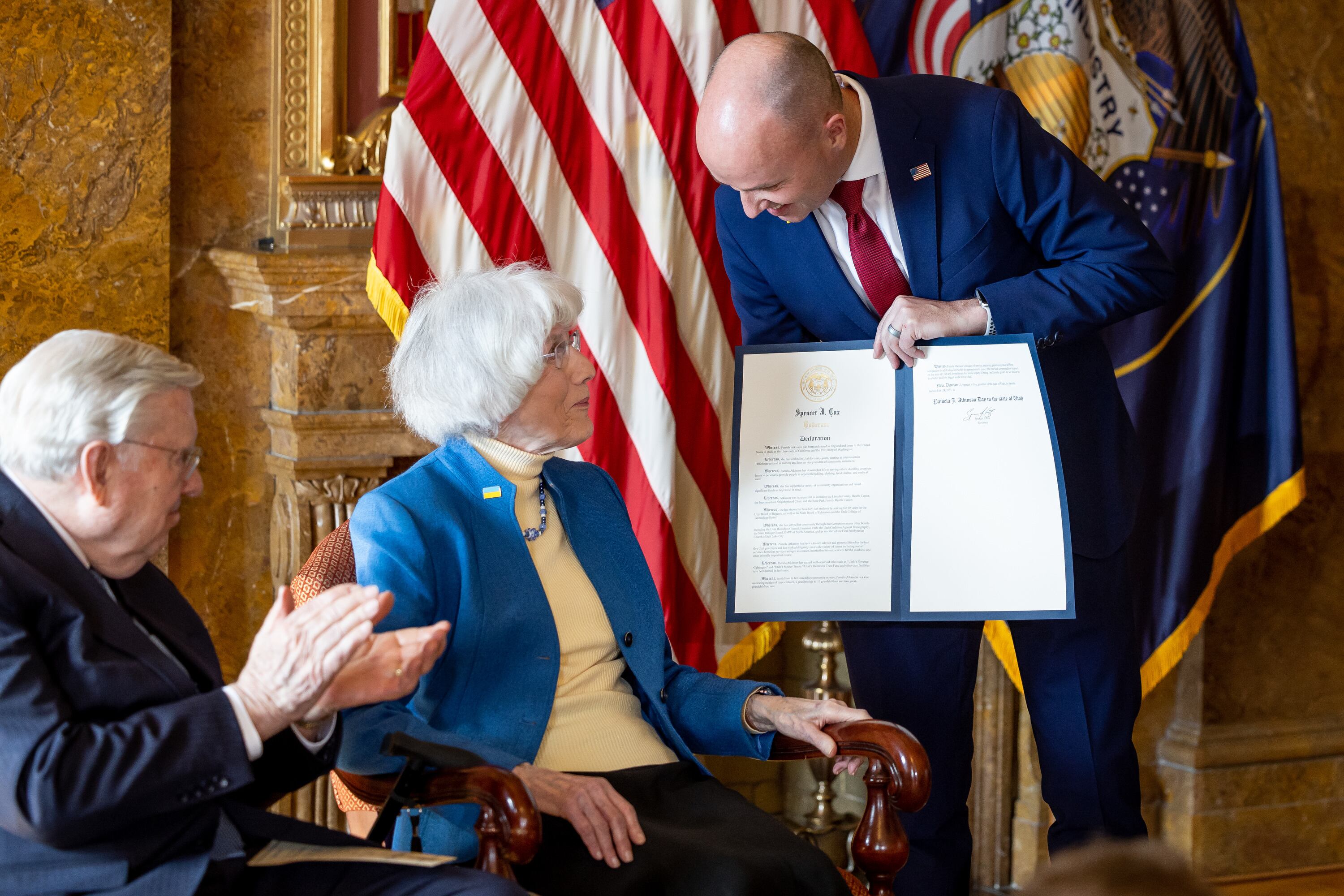 Gov. Spencer Cox presents Pamela Atkinson with a signed proclamation creating Pamela Atkinson Day during an event at the Capitol in Salt Lake City on Feb. 24, 2023. Cox spoke at Atkinson's funeral on Friday.
