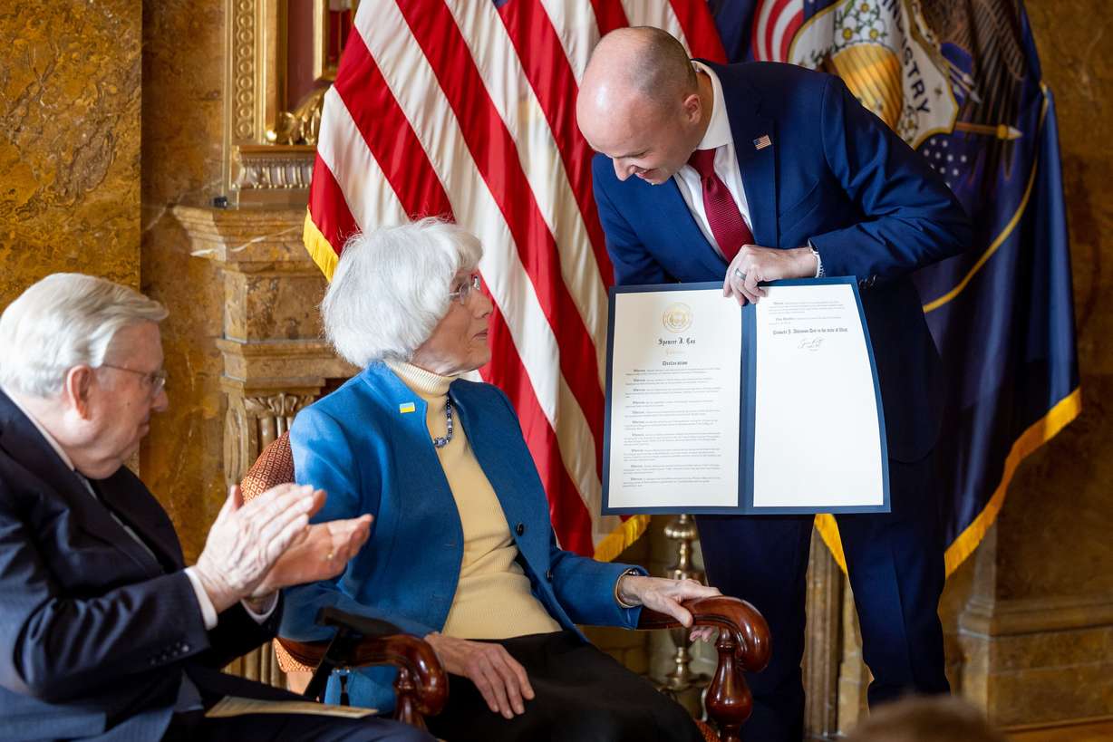 Gov. Spencer Cox presents Pamela Atkinson with a signed proclamation creating Pamela Atkinson Day during an event at the Capitol in Salt Lake City on Feb. 24, 2023. Cox spoke at Atkinson's funeral on Friday.