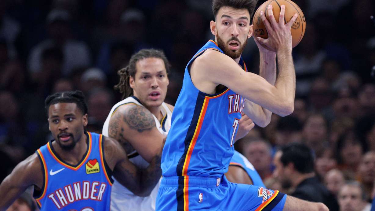 Oklahoma City Thunder center Chet Holmgren, right, grabs a rebound in front of Thunder guard Cason Wallace, left, and Denver Nuggets forward Aaron Gordon, center, during the first half of an NBA basketball game Thursday, Oct. 22, 2026, in Oklahoma City.