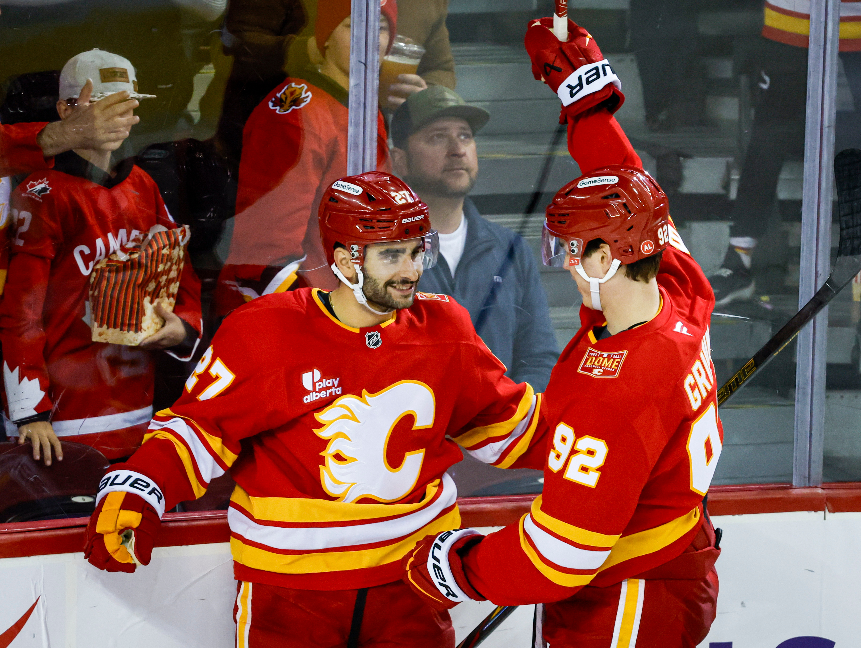 Calgary Flames' Matt Coronato, left, celebrates after his goal with teammate Matvei Gridin, right, during the third period of an NHL hockey game against the Seattle Kraken in Calgary, Alberta, Friday, Oct. 30, 2026. 
