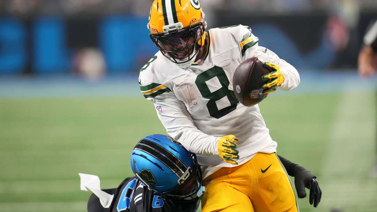 Green Bay Packers running back Josh Jacobs (8) breaks a tackle by Detroit Lions cornerback Keith Abney II (6) during a touchdown reception in the second half of an NFL football game, Sunday, Oct. 25, 2026, in Detroit.