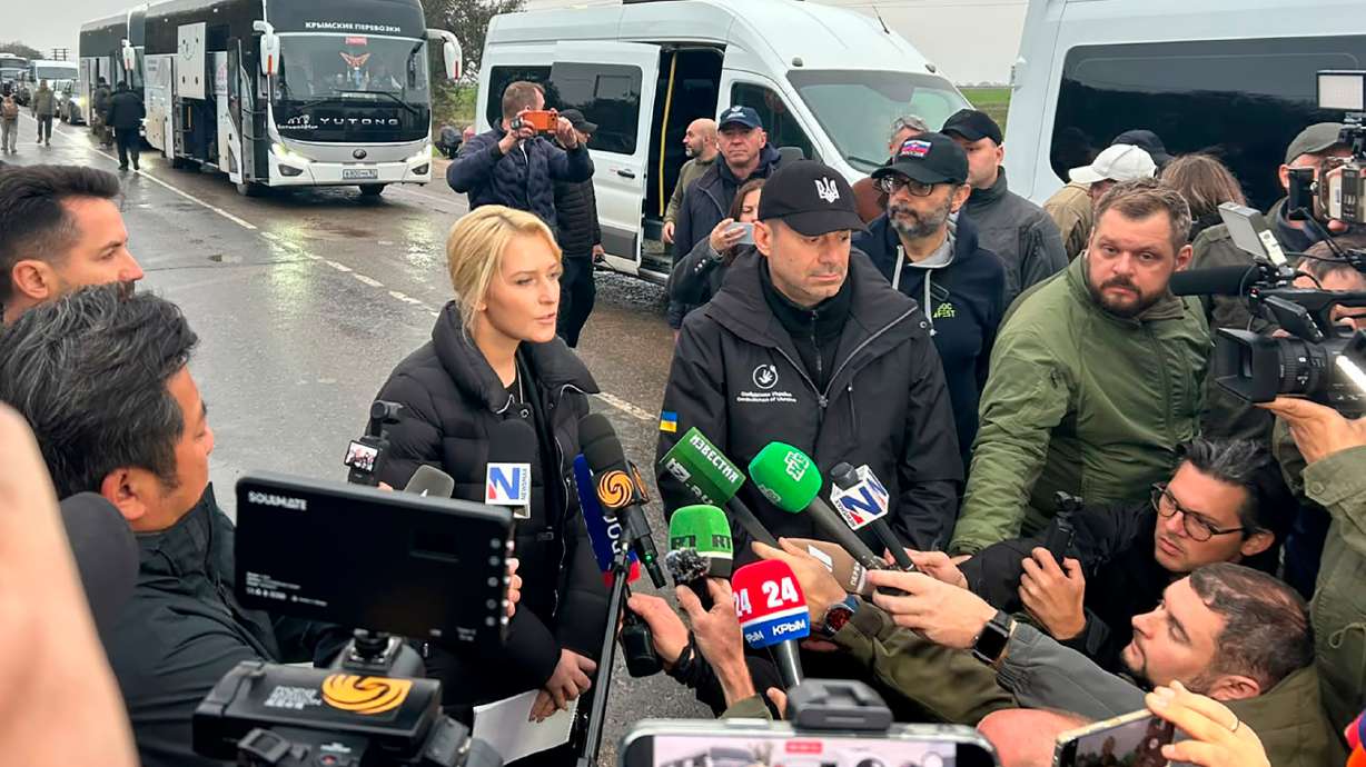 In this photo provided by the Office of the Ombudsman of Ukraine, Ukraine's Ombudsman Dmytro Lubinets, center right, and Russian Ombudsman Yana Lantratova speak with journalists before departing for Oleshky to evacuate local residents to a safe area during a local ceasefire linked to a humanitarian mission in Ukraine's Kherson region, Friday. CORRECTION: change position of Dmytro Lubinets from center left to center right