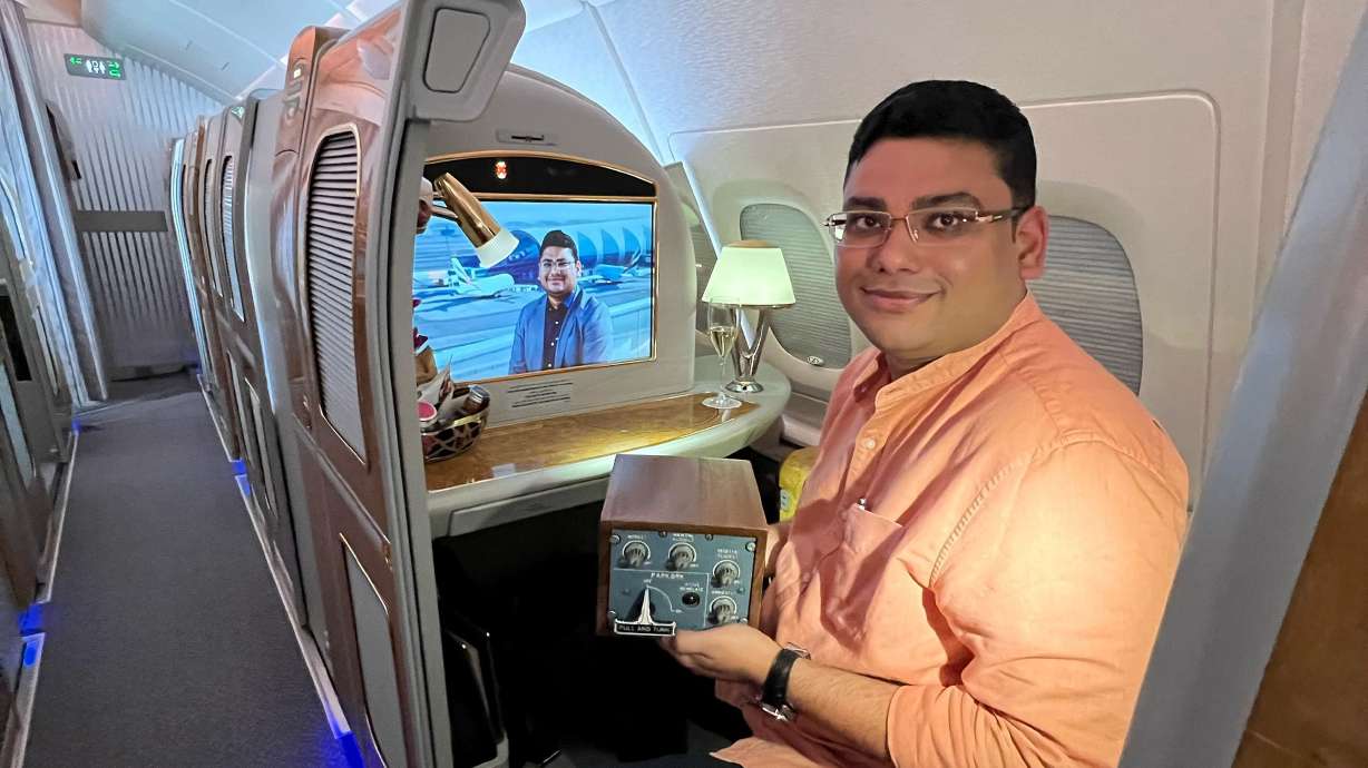 Arun Rajagopal, holding an Emirates A380 parking brake while a documentary featuring the A380 superfan plays in the background.