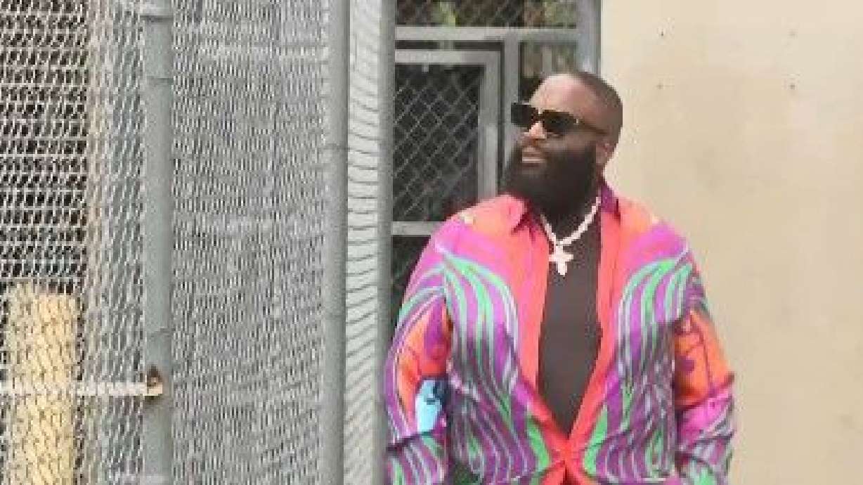 Rick Ross exits the courthouse in Miami on Friday.A felony charge against the rapper that stemmed from his arrest in connection with a domestic violence incident was dropped, as prosecutors cited insufficient evidence to pursue it.