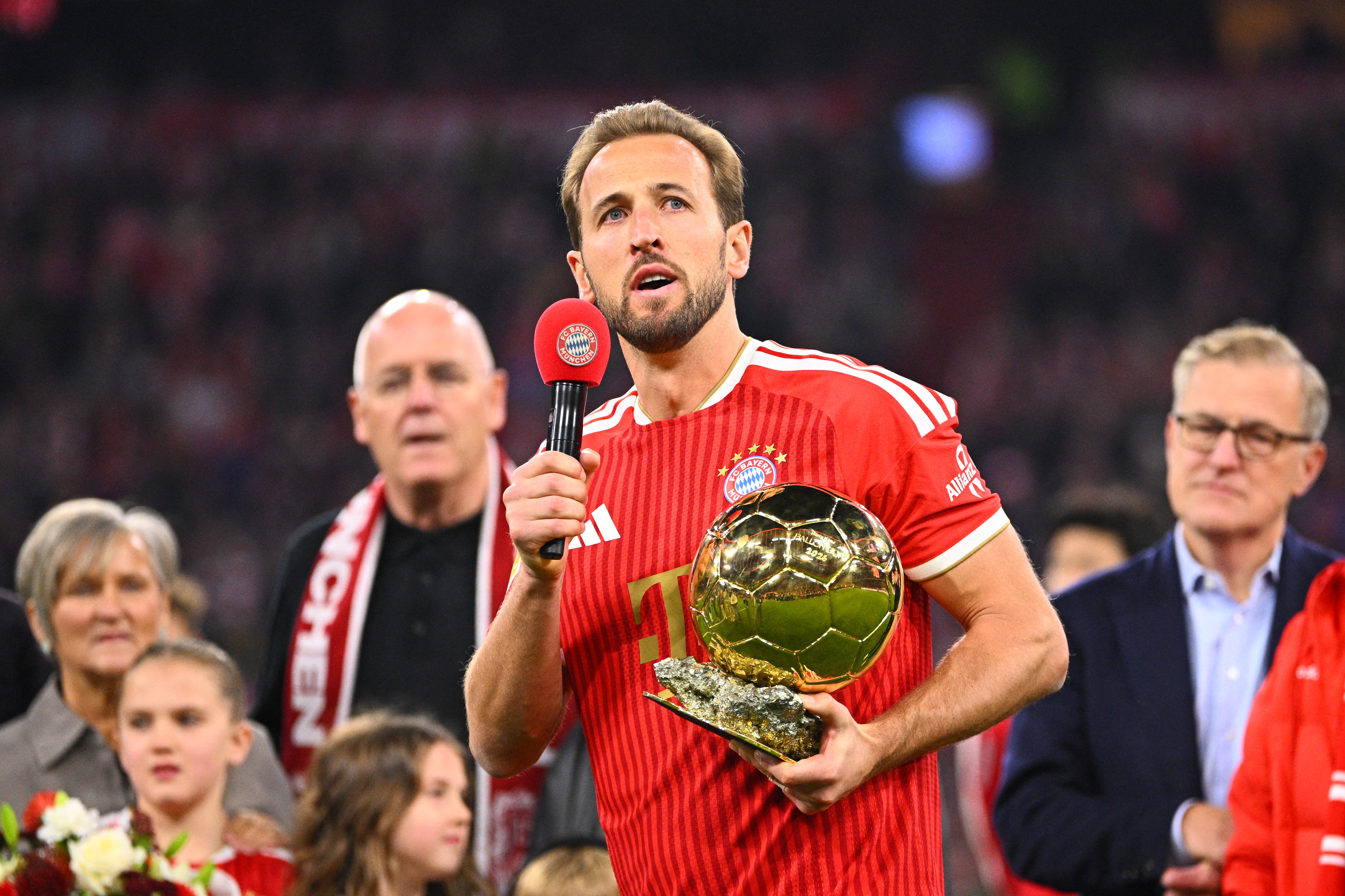 Munich's Harry Kane holds the 2026 Ballon d'Or trophy before the German Bundesliga soccer match between FC Bayern Munich and Borussia Dortmund in Munich, Germany, Saturday, Oct. 31, 2026. 