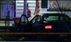 Fugitive crashes car onto porch