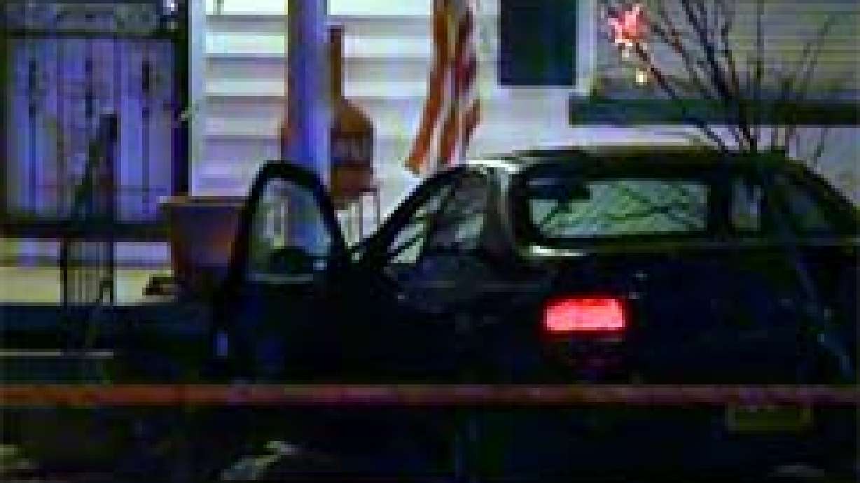 Fugitive crashes car onto porch