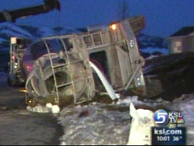 Cement truck loses brakes, ends up on its side