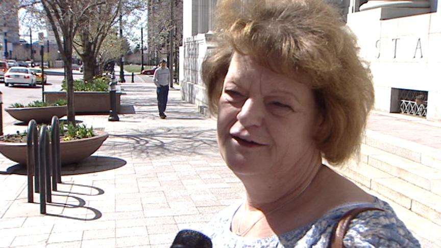 Family standing by woman accused of stealing DWS clients' identities