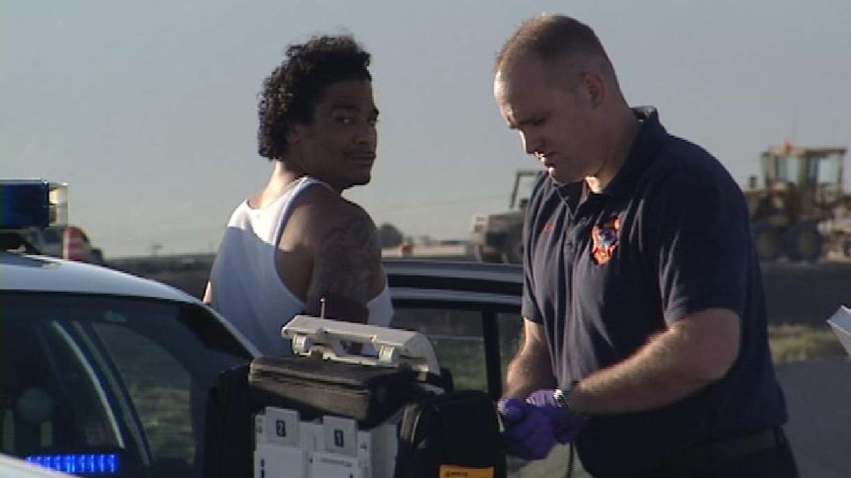 Man Walks Through Traffic, Climbs on Top of Bus