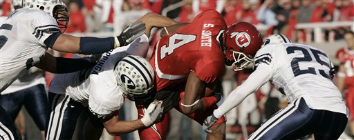 Utah wide receiver Sean Smith (4) is surrounded and tackled by Brigham Young linebackers Cameron Jensen, Kelly Poppinga and defensive back Quinn Gooch, left to right, during the second quarter of their college football game Saturday, Nov. 25, 2006, in Salt Lake City. (AP Photo/Douglas C. Pizac)