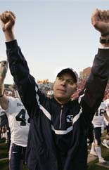 Brigham Young head coach Bronco Mendenhall raises his fists in victory to the BYU fans after beating Utah. (AP Photo/Douglas C. Pizac)