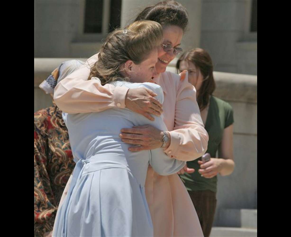 Fundamentalist Church of Jesus Christ of Latter Day Saints mothers hug after the news of a court ruling in their favor in San Angelo, Texas, Thursday, May 22, 2008. An Austin, Texas appeals court ruled that the state had no cause to take their children. (AP Photo/LM Otero)