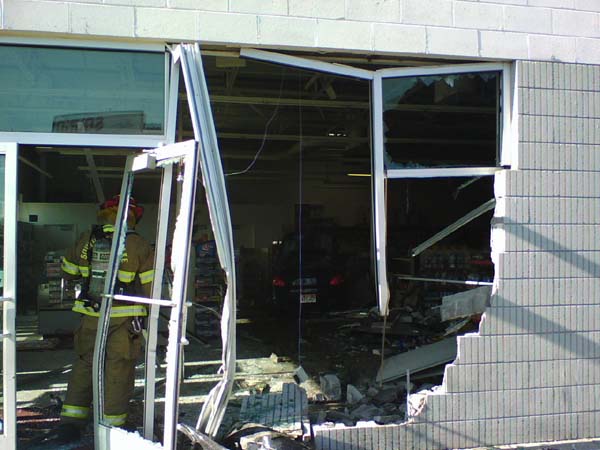 Car crashes into store and bursts into flames