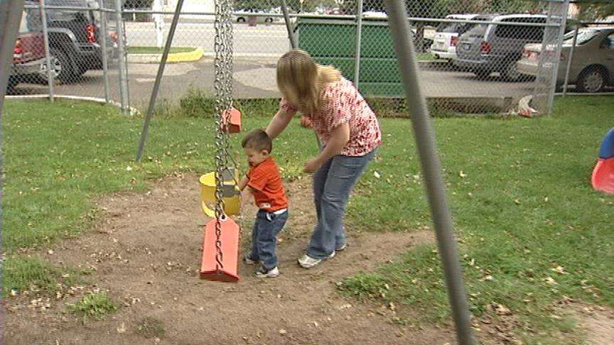 Nicole Halm plays with her son, Brandon, at a park.