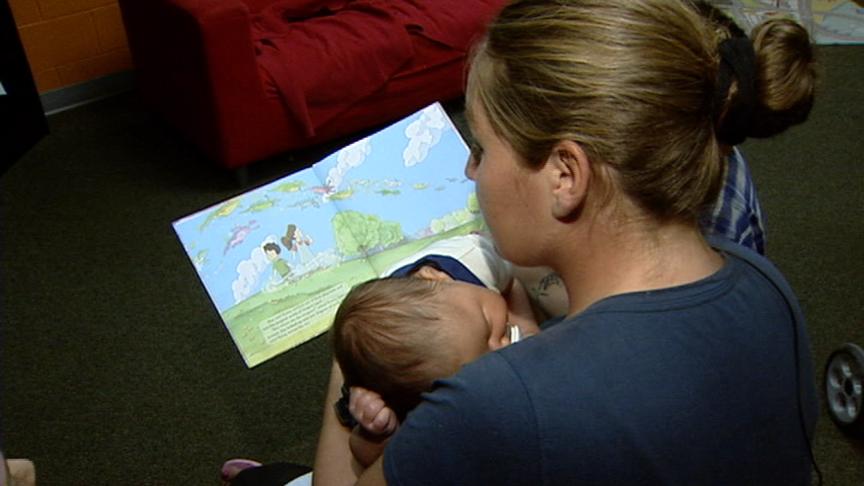 Treasa Hansen reads to her children at the Road Home shelter
