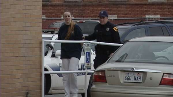 Dana Marie Averett being escorted by police.