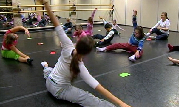 Woman teaching children with disabilities to love dance