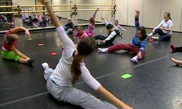 Woman teaching children with disabilities to love dance