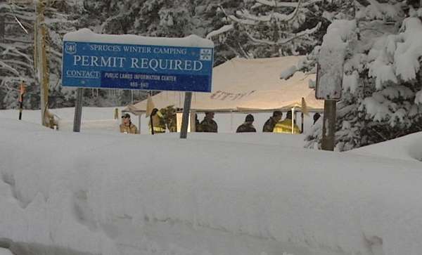 Investigators search for evidence underneath a tent they put up at the crime scene.
